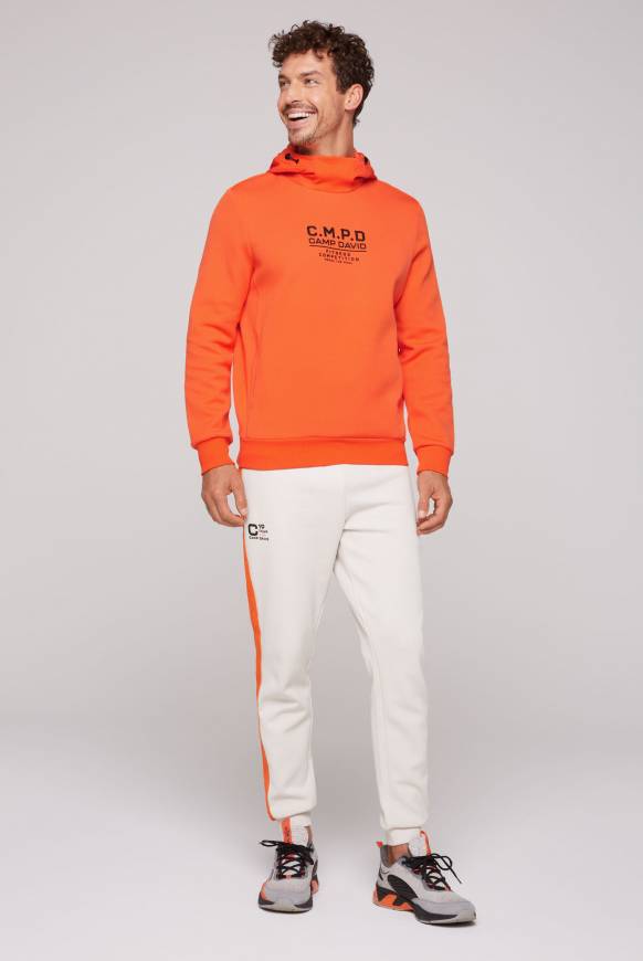 Soccx Hoodie im Materialmix mit Artwork und Rückentasche signal orange Hotsell
